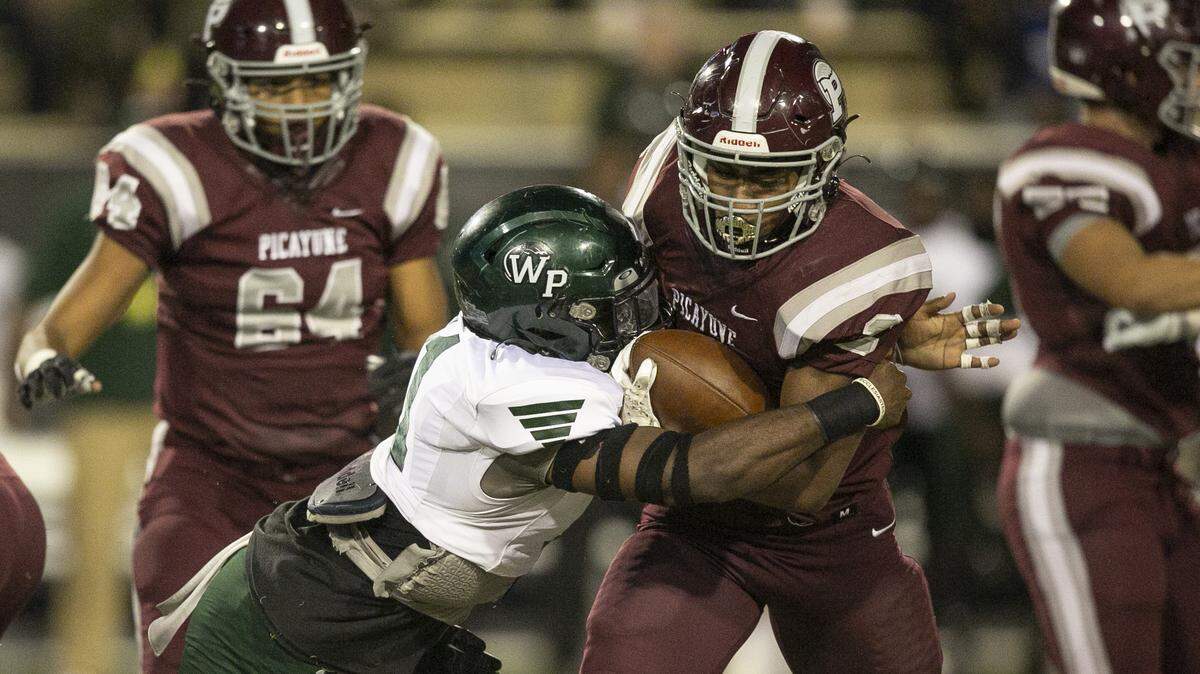 Picayune’s Dante Dowdell gets tackled during the 5A State Championship game at M.M. Roberts Stadium in Hattiesburg on Saturday, Dec. 4, 2021.