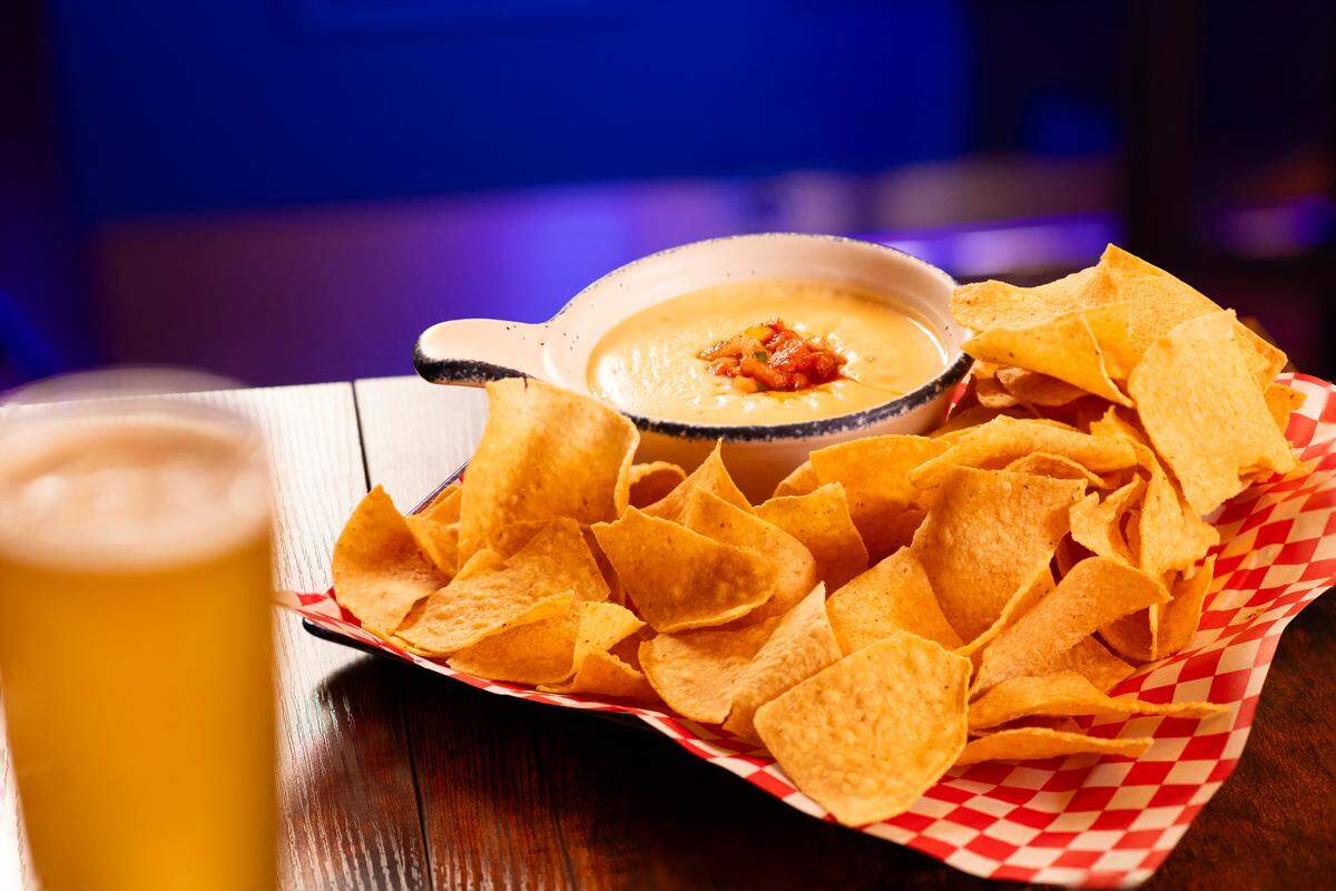 A stack of chips and queso and a beer await at MGM Golf and Lux Lounge at Beau Rivage Resort and Casino in Biloxi. The virtual sports venue and lounge are newly opened.