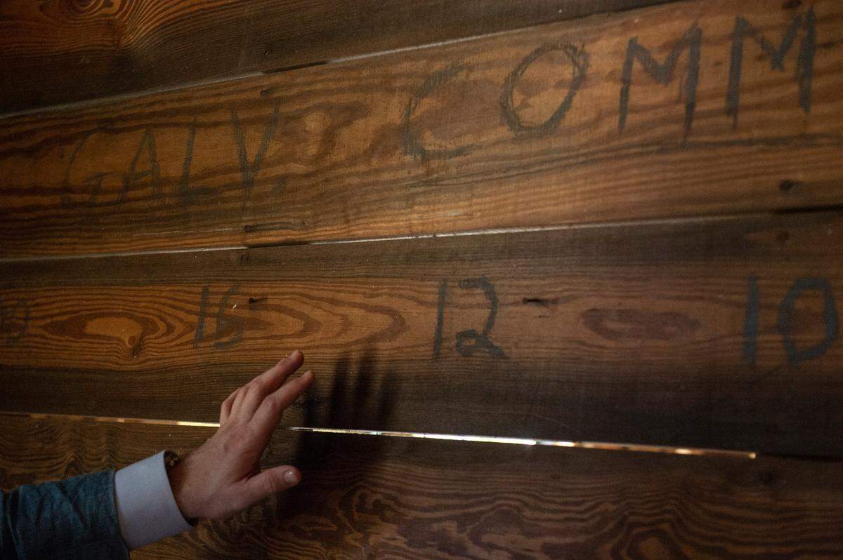 Christian Shane Galvin, owner of Christian Shane Intl., the company that is developing Farragut Lofts, points out writing on the wall from when the building was home to the McDonald Hardware & Lumber Co. building, in Bay St. Louis on Thursday, June 30, 2022.