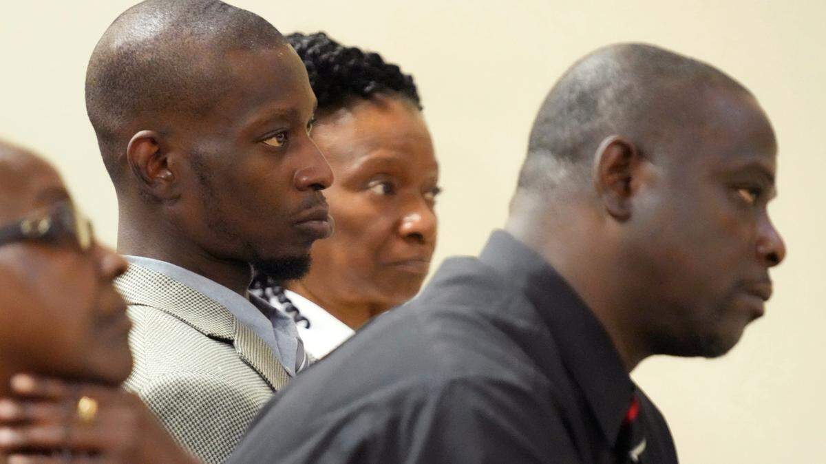 Michael Corey Jenkins, center, and Eddie Terrell Parker, right, listen as one of six former Mississippi law officers pleads guilty to state charges at the Rankin County Circuit Court in Brandon last year. The two Black men who were tortured by six former Mississippi law enforcement officers in a violent episode last year called Monday for a federal judge to impose strict penalties at sentencing hearings set to occur this week.