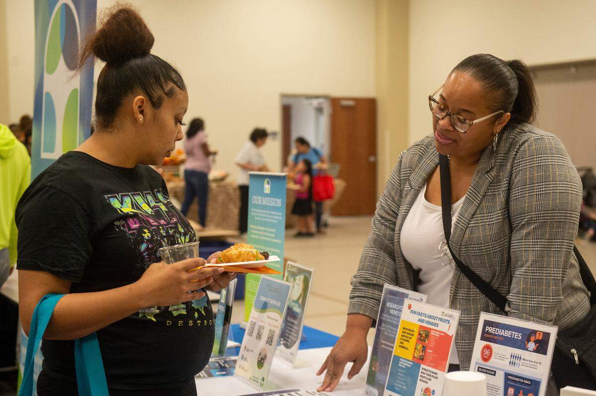 Expecting families meet with vendors during a community baby shower event at Lyman Community Center in Gulfport on Thursday, Nov. 14, 2024.