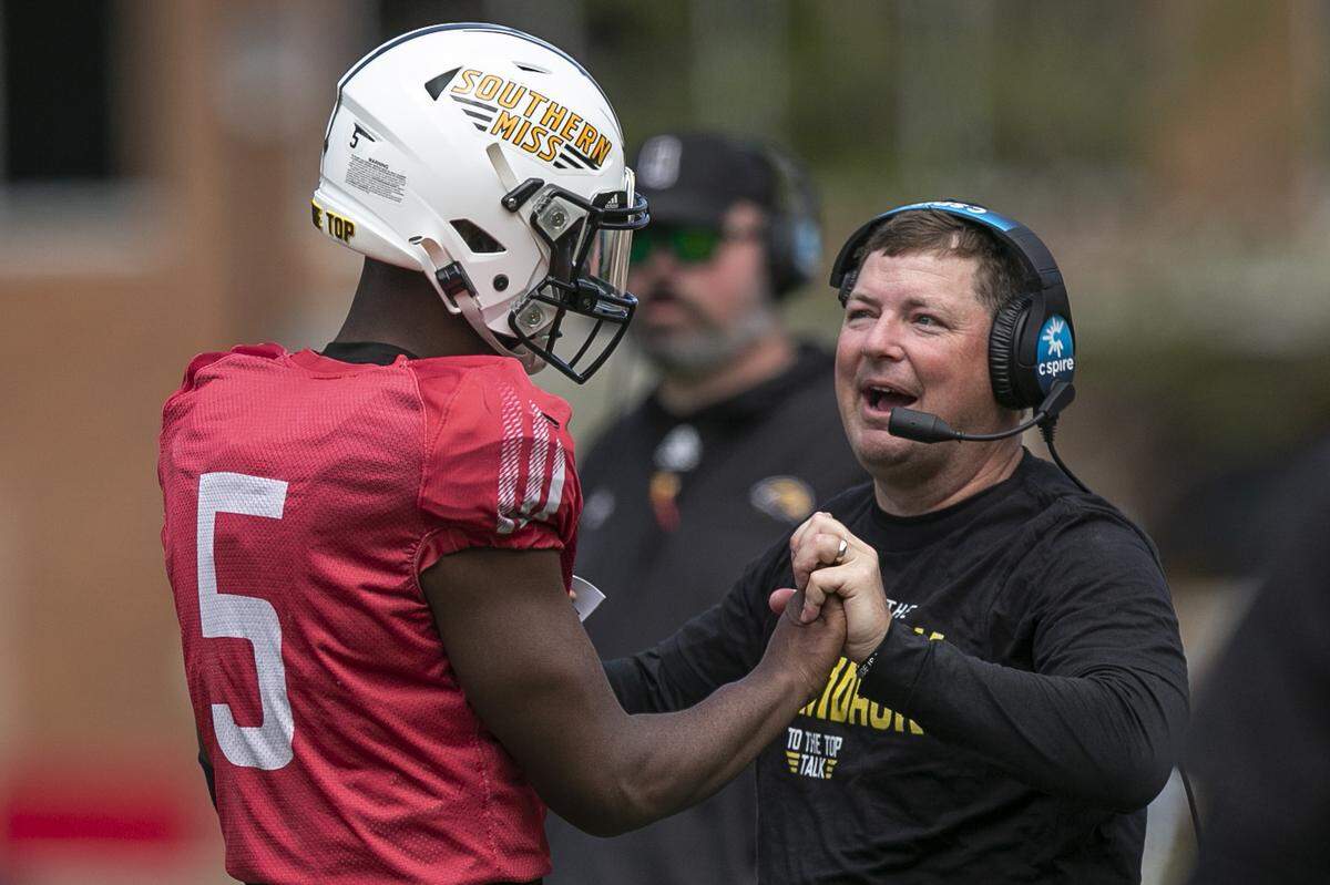 Coach Will Hall embraces Ty Keyes during the Spring Game at M.M. Roberts Stadium in Hattiesburg on Friday, April 1, 2022.