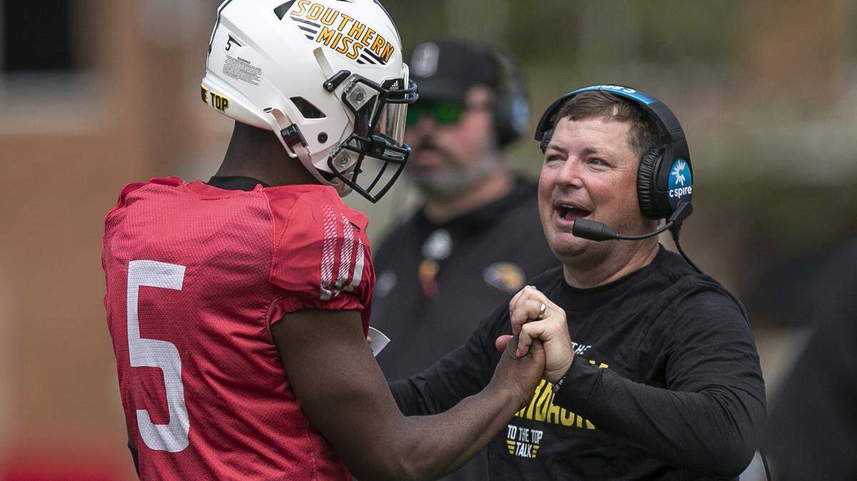 Coach Will Hall embraces Ty Keyes during the Spring Game at M.M. Roberts Stadium in Hattiesburg on Friday, April 1, 2022.