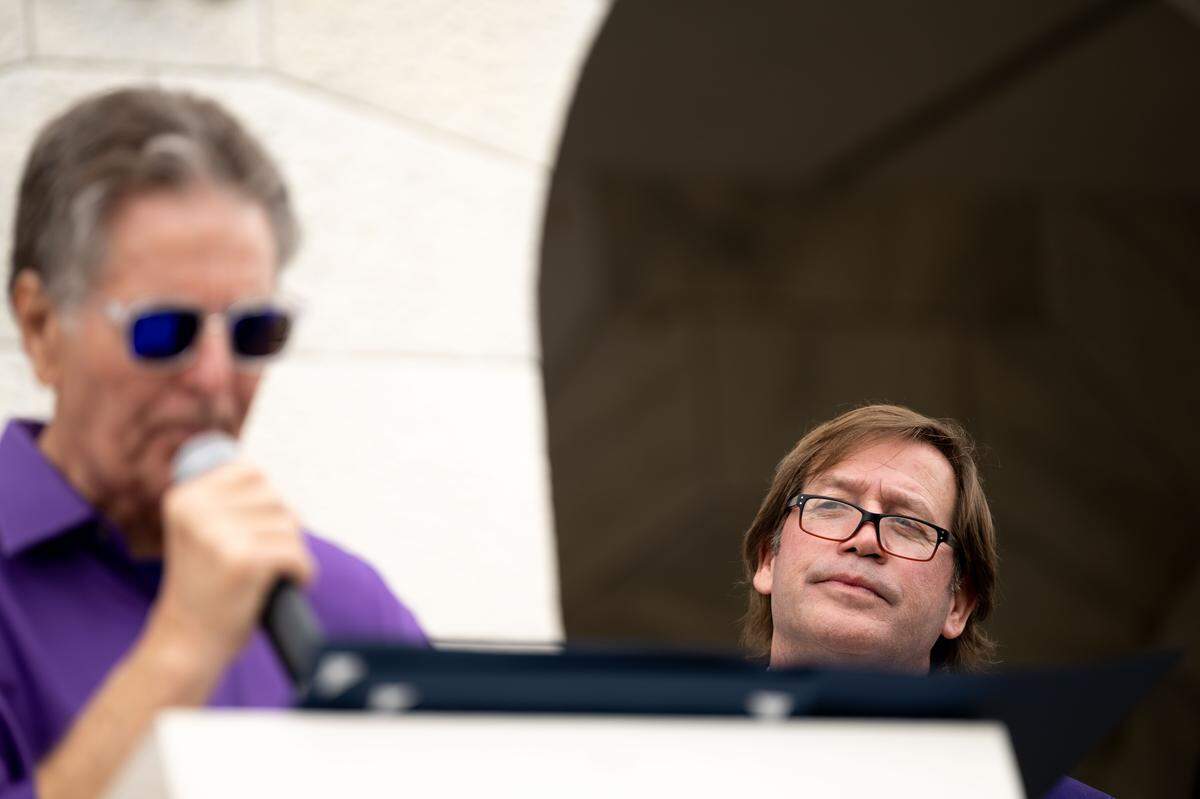 Mark Mavar, right, listens as Mayor of Biloxi Andrew Glitch, left, speaks during the Gulf Coast Carnival Association’s Fat Tuesday parade in Biloxi on Tuesday, Feb. 17, 2026.