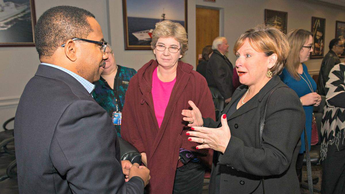 ANDREW YOUNG/HUNTINGTON INGALLS INDUSTRIES 
 Edmond Hughes (left), vice president of human resources and administration at Ingalls Shipbuilding, speaks with Resurrection Elementary School teachers Laura Hudson and Kellea Newton about their school's STEM project.