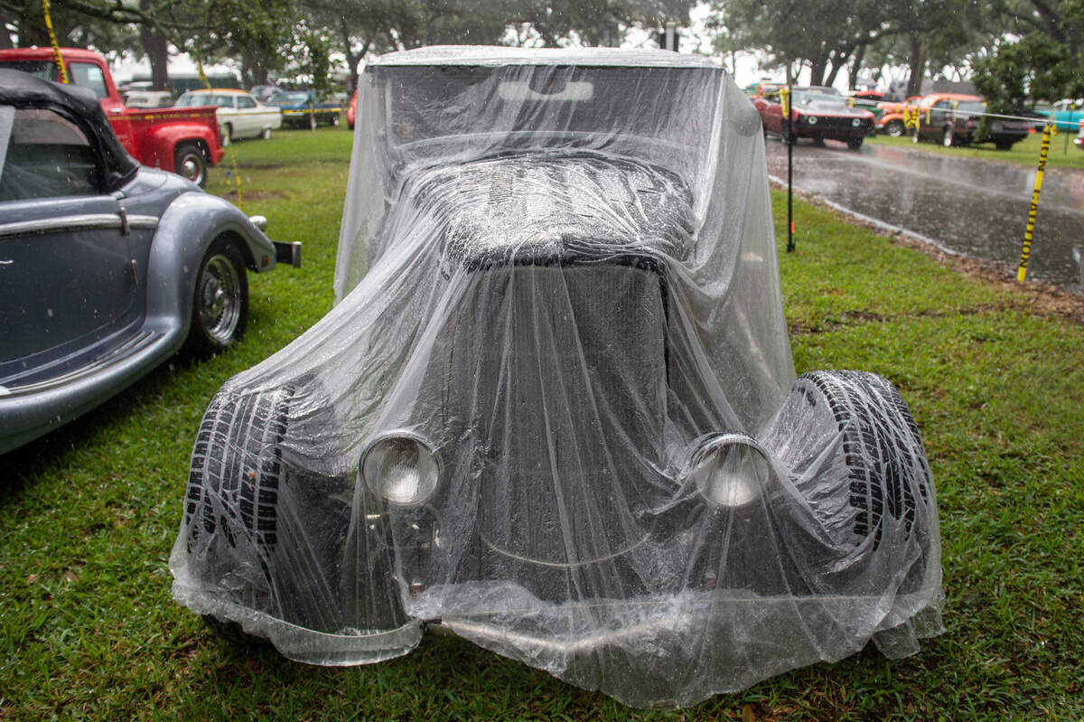 A clear plastic cover protects a car from the rain during Cruisin’ The Coast on Monday, Oct. 4, 2021.