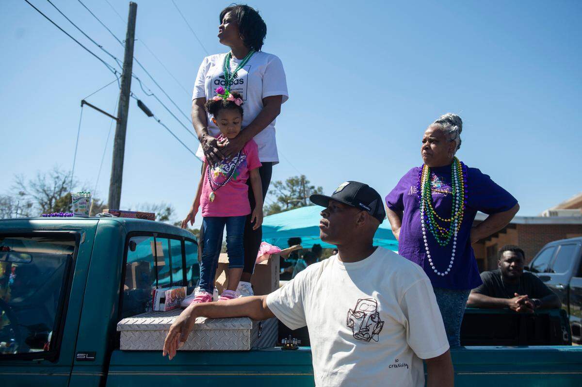 Parade attendees wait to catch beads during the Jackson County Carnival Association Mardi Gras parade in Pascagoula on Saturday, March 1, 2025.