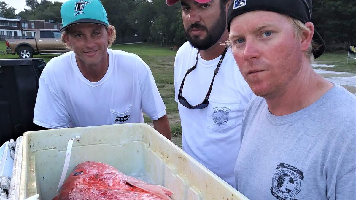 Mark Alan Ross, Derrick Saucier, and Jarrod Davis look at $3,000 worth of red snapper Sunday following the Ocean Springs Marine Mart Fishing Rodeo. The fishing partners caught the three fish Saturday before breaking the steering on their boat. Ross caught the champion snapper, which weighed 22 points and garnered him a check for $1,500. Davis caught a 20-pound snapper, which was good for second and check for $1,000. Saucier's snapper came in at 18.50 pounds, good enough for third.