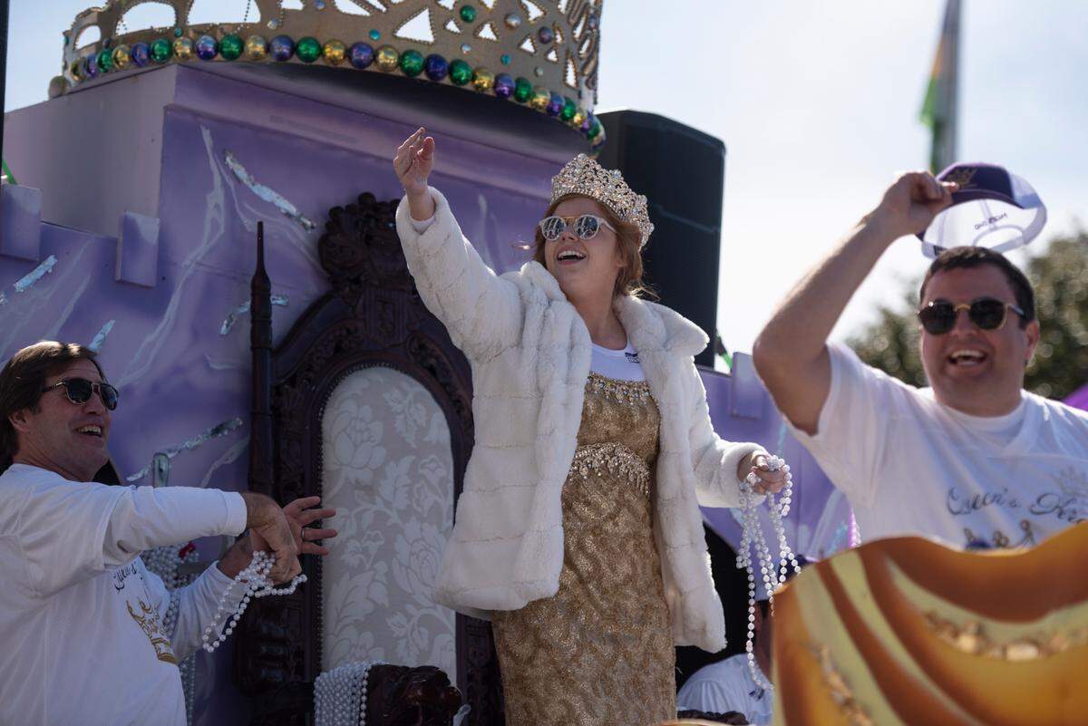 Queen Ixolib Elizabeth Polk throws beads from her float during the Gulf Coast Carnival Association’s Mardi Gras parade in Biloxi on Tuesday, Feb. 13, 2024.