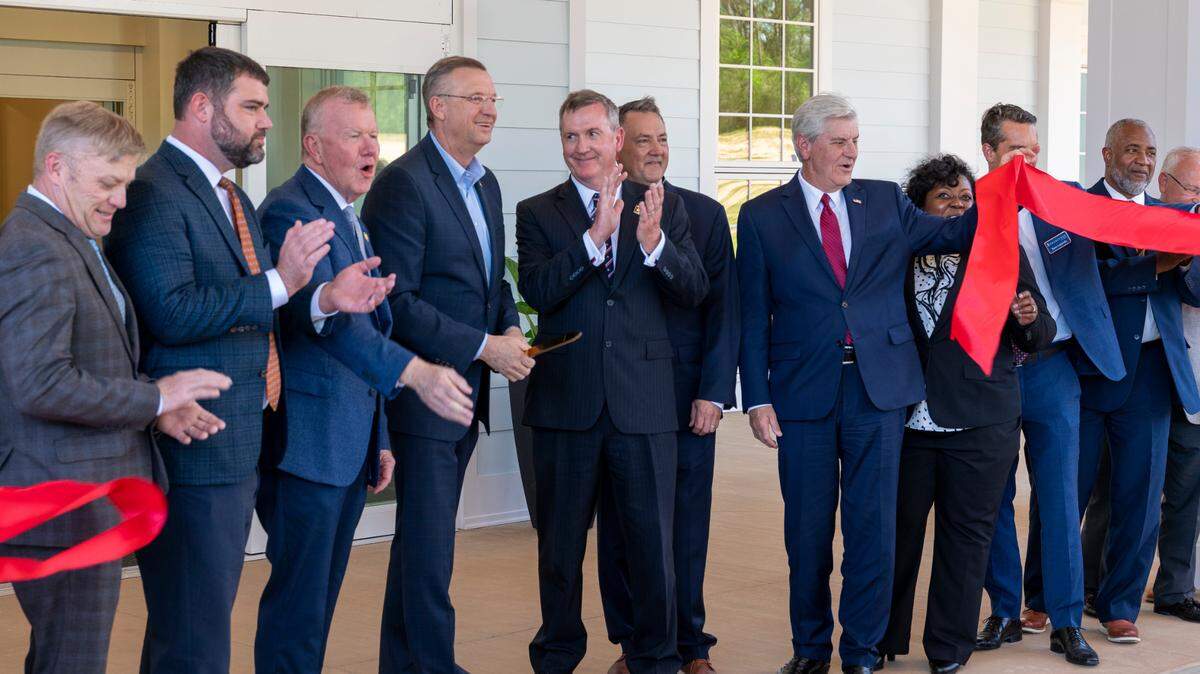 From left to right, U.S. Rep. Mike Ezell, VA Secretary Douglas Collins, and former Mississippi Gov. Phil Bryant gather with others for the ceremonial ribbon-cutting at the Canizaro Veterans Home.