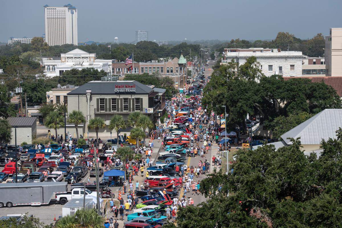 Spectators walk among classic cars in downtown Biloxi during the Biloxi Block Party, one of many Cruisin’ the Coast events, on Wednesday, Oct. 4, 2023. Nearly 10,000 vehicles are registered for 2023’s Cruising’ the Coast.