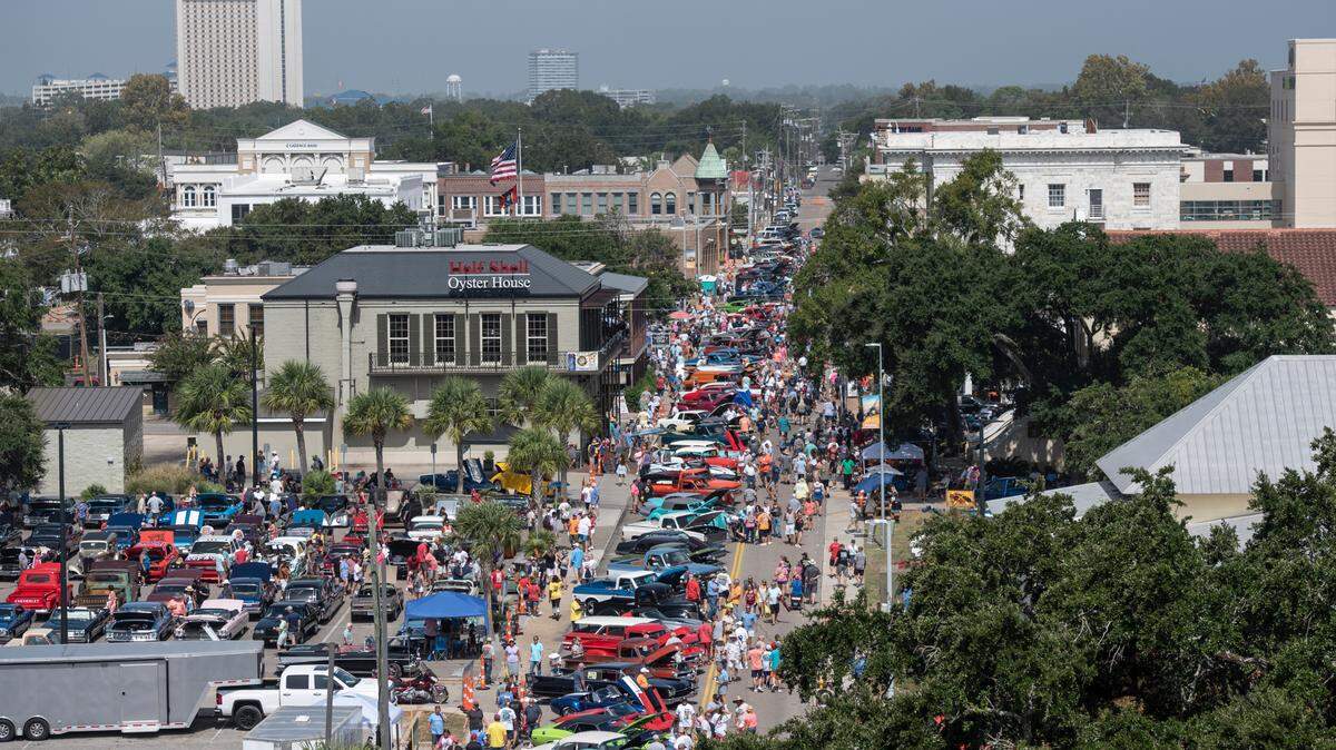 Spectators walk among classic cars in downtown Biloxi during the Biloxi Block Party, one of many Cruisin’ the Coast events, on Wednesday, Oct. 4, 2023. Nearly 10,000 vehicles are registered for 2023’s Cruising’ the Coast.