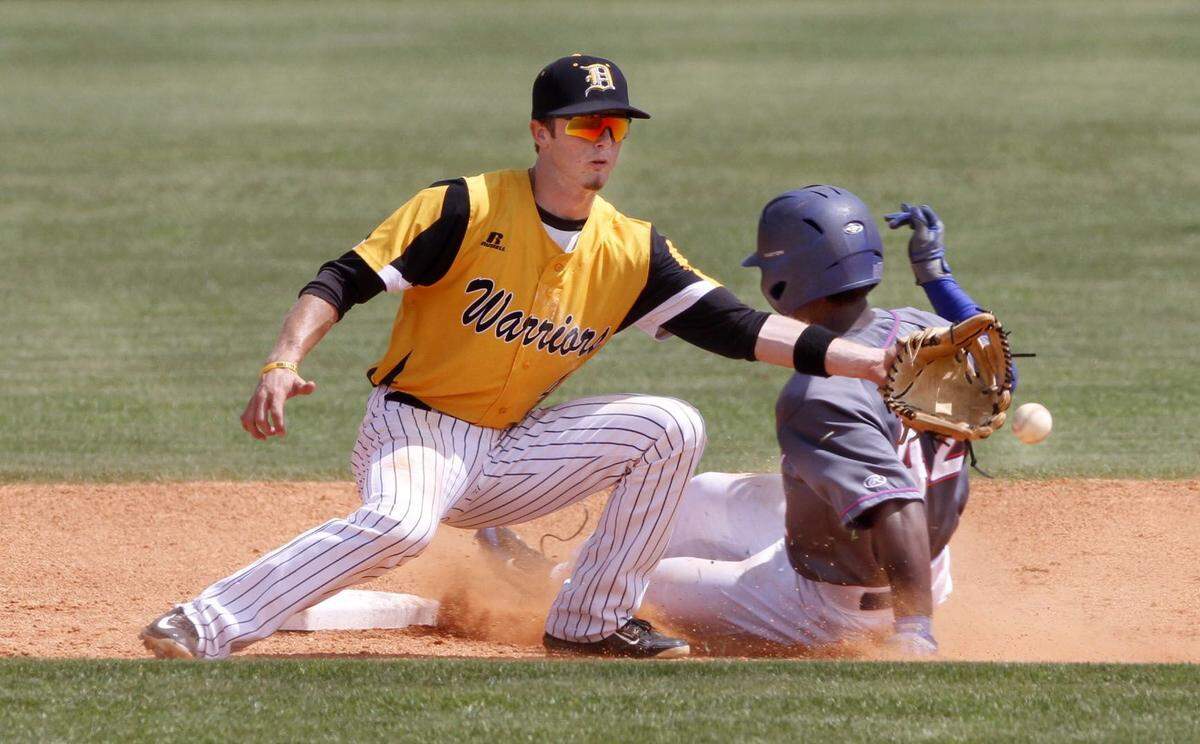 TIM ISBELL/SUN HERALD  The ball kicks off the tip of D'Iberville shortstop Dylan Hardy as Gulfport's Dillon Brown is safe at second base, Friday, April 3, 2015.