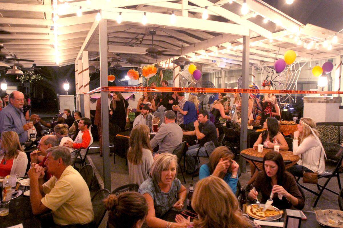 TIM ISBELL/SUN HERALDThe night life in downtown Ocean Springs is a popular affair as establishments on Washington Avenue and Government Street get plenty of business in Oct. 2014. A new state law could permit the city to establish a downtown leisure district that would for the first time allow patrons to bar hop with alcoholic beverages in go cups.