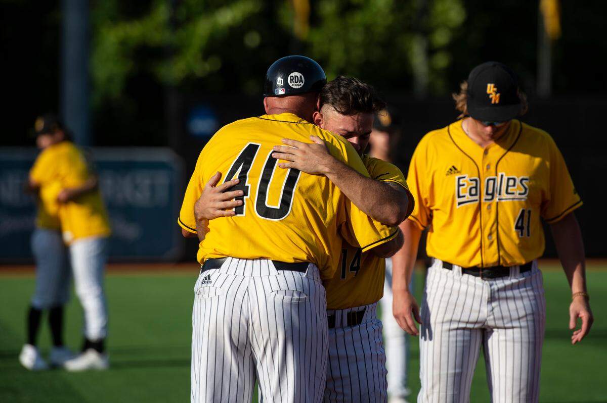 Coach Scott Berry hugs his players after losing their chance at going to the College World Series during the Super Regionals Final at Pete Taylor Park in Hattiesburg on Sunday, June 12, 2022.