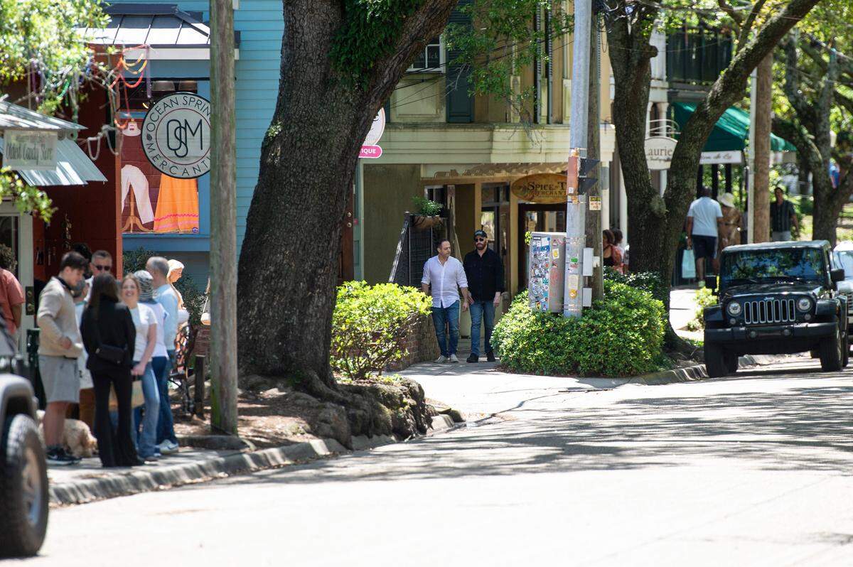 Actor John Travolta, center, and another cast member walk down Washington Avenue on the set of Cash Out 3 during filming in Ocean Springs on Tuesday, April 8, 2025.