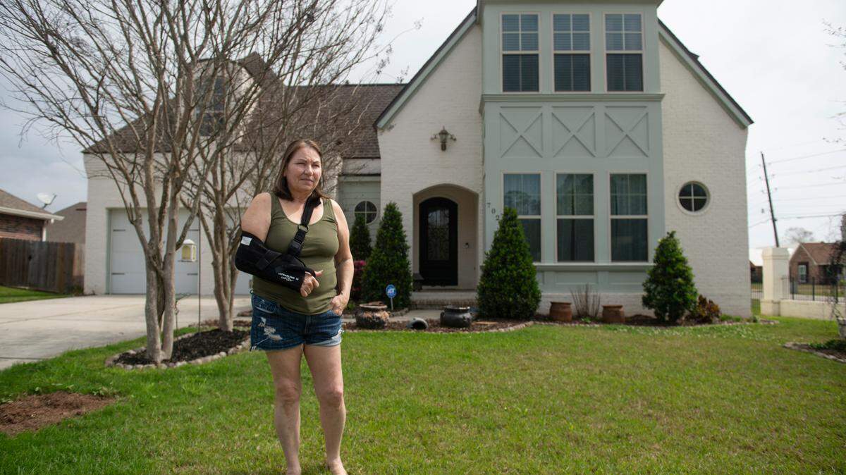Teresa Teague stands outside her home in Biloxi on Thursday. Teague won the house in the 2015 Mississippi Gulf Coast St. Jude Dream Home Giveaway and alleges that home builder Elliott Homes improperly installed a portion of the roof, leading to rot and termites.