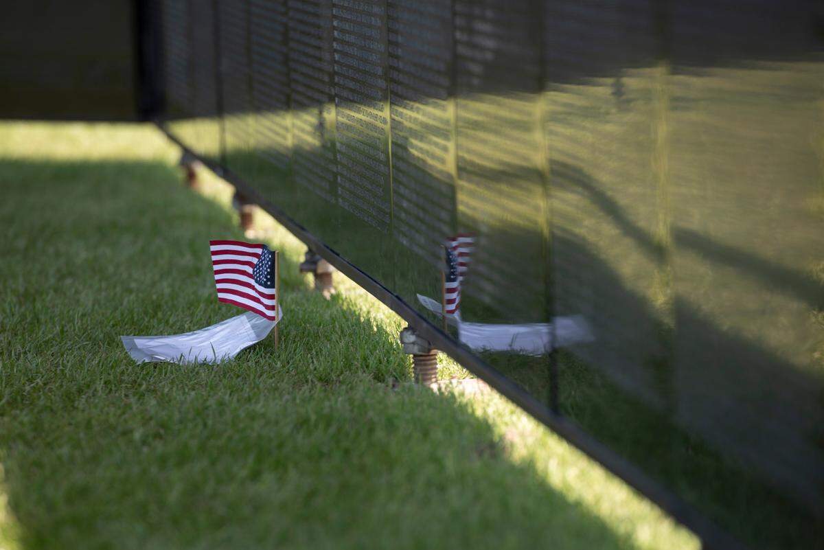 An American flag and a note left at The Wall That Heals, a traveling three-quarter scale replica of the Vietnam Veterans Memorial in D.C., while it is on display at the D’Iberville Sports Complex in D’Iberville on Thursday, April 10, 2025.