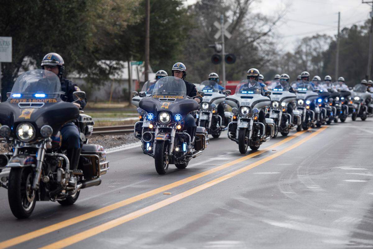 Mississippi Highway Patrol state troopers lead a procession escorting the body of George County Sheriff’s Deputy Jeremy Malone from his funeral at Agricola Baptist Church in George County on Friday, Jan. 12, 2024.
