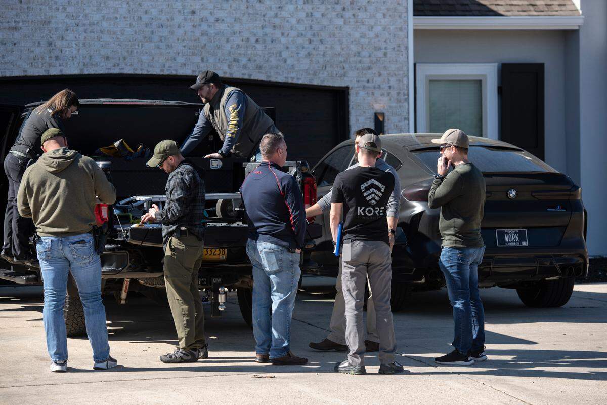 Drug Enforcement Administration agents and other law enforcement officers search two cars as a part of raids conducted on the home of Biloxi Councilman Robert Deming III on Thursday, Jan. 26, 2023. Agents would not say specifically what they were looking for or what they found, but agents also conducted raids on several locations of The Candy Shop & Kratom, a kratom store chain owned by Deming.
