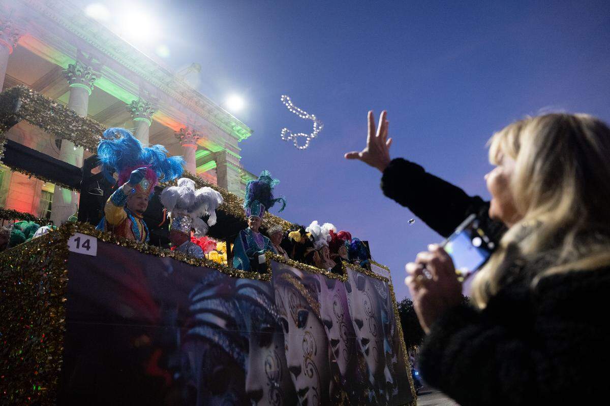 Mardi Gras beads are passed out from floats to parade attendees during a 12th Night Celebration in Biloxi on Monday, Jan. 5, 2026.