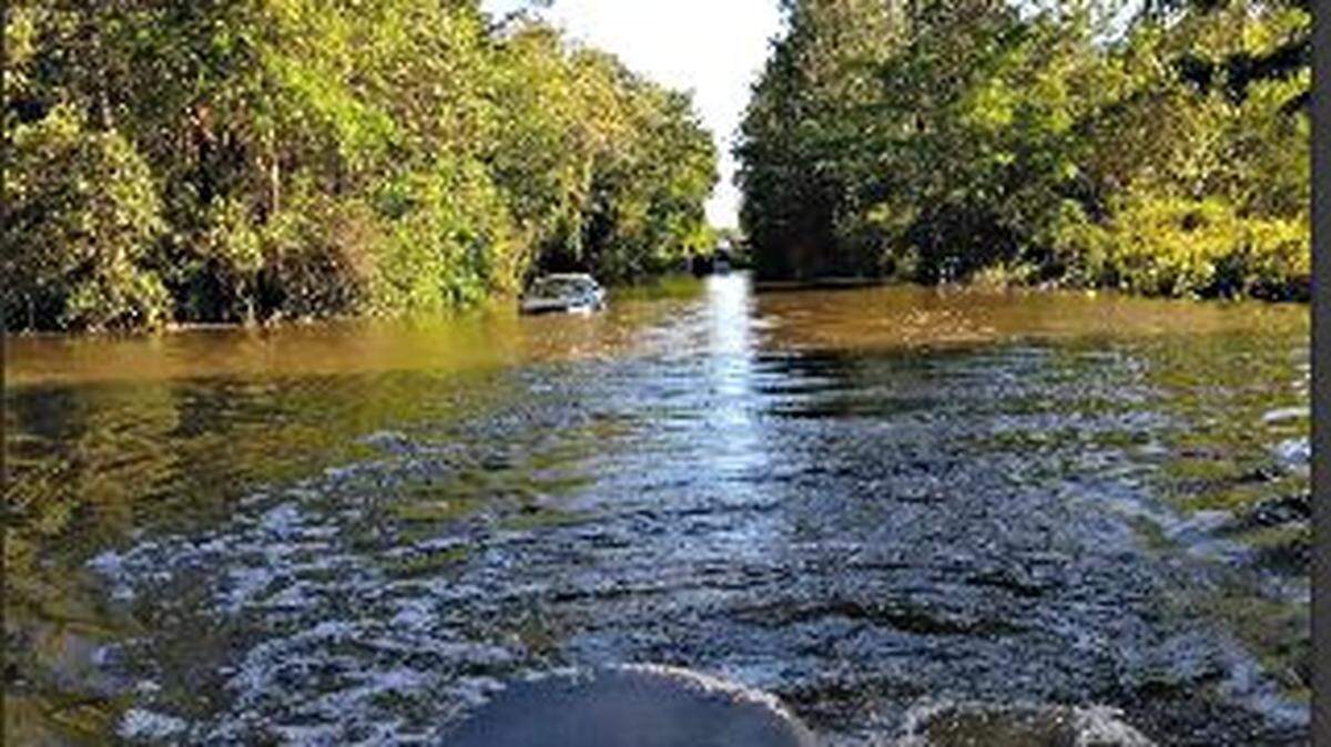 Two men used a boat to rescue Indianapolis visitors whose car became stranded on South River Road in Gulfport on Sunday in flooding from the weekend's severe thunderstorms. The stranded group was visiting the Mississippi Coast for Black Spring Break.