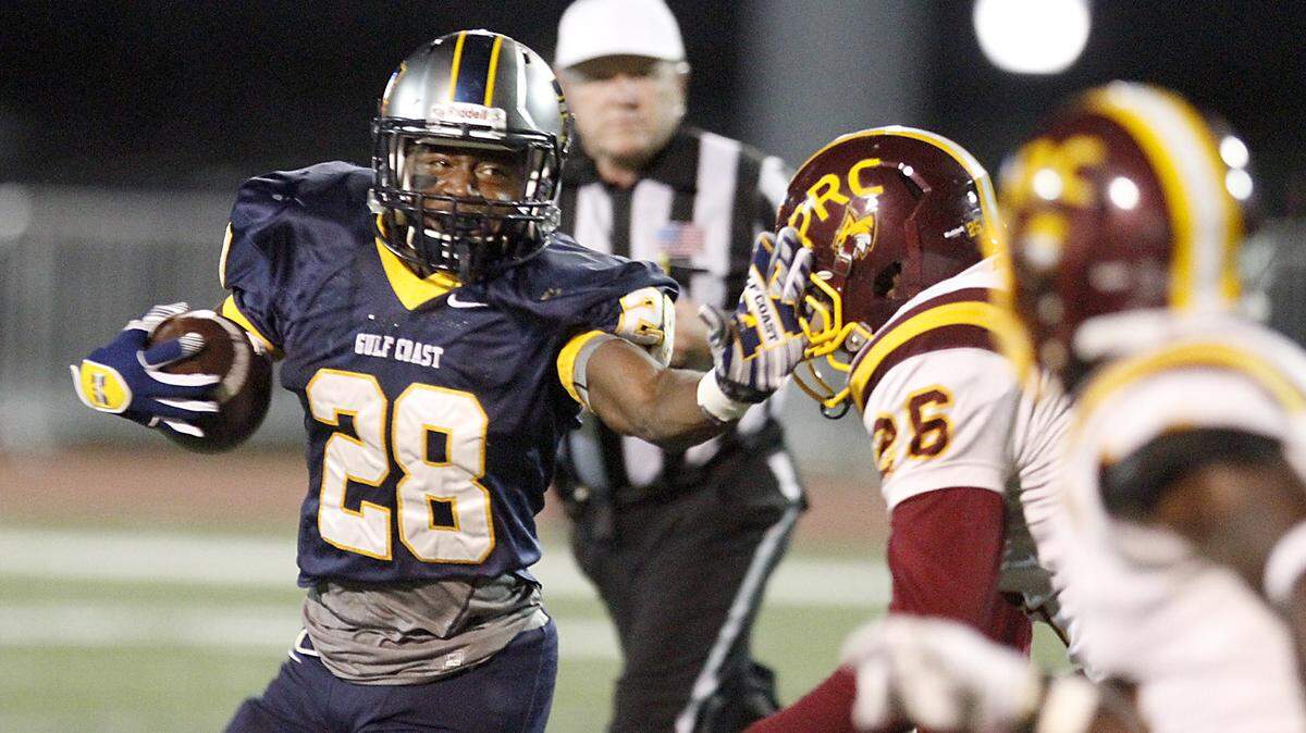TIM ISBELL/SUN HERALD 
 MGCCC's T'Rod Daniels gives PRCC's Keyshaun Simmons a stiff arm in an attempt to shed a tackle, Thursday, Oct. 8, 2015.
