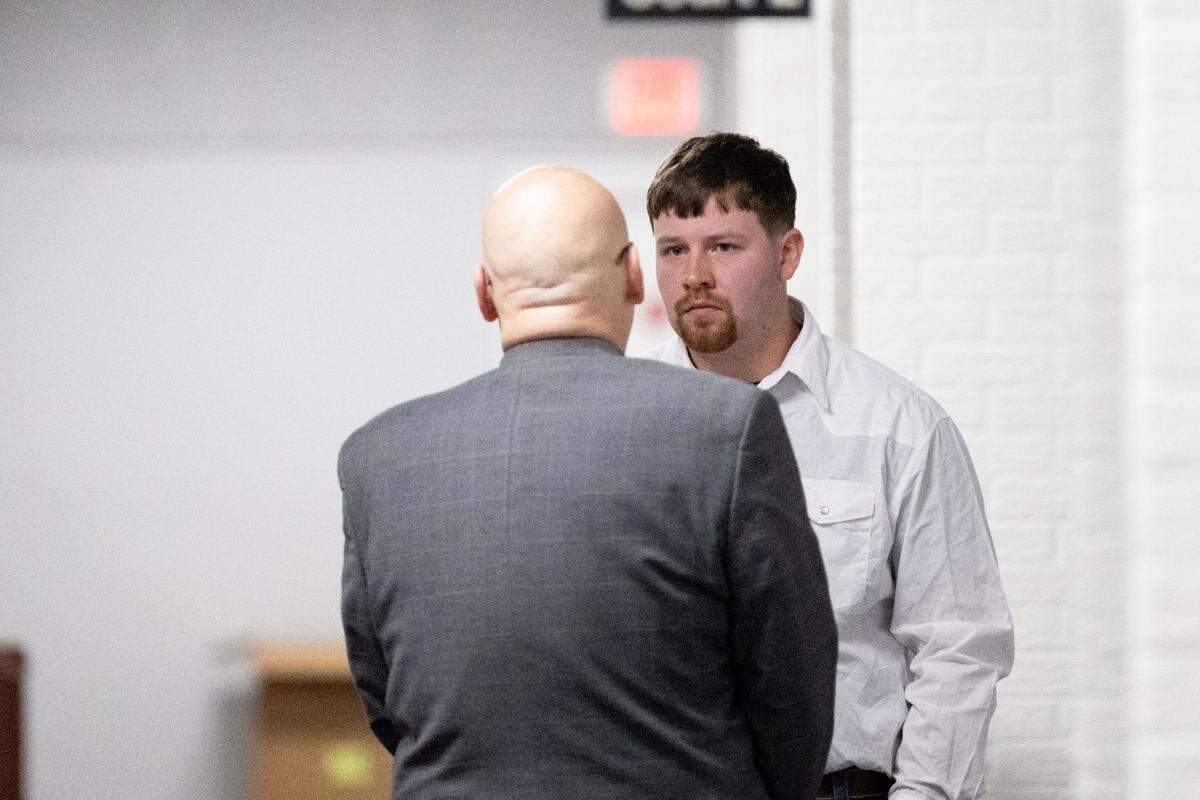 Ian Schexnayder talks with his attorney Wednesday after pleading guilty in a bribery case involving Alan Moran at Harrison County Circuit Court.