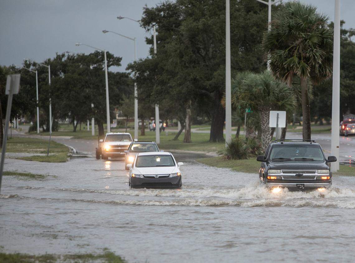 Vehicles drive through floodwater at U.S. 90 and Miramar Avenue in Biloxi. The Honda Civic, stalled out in the water. Hurricane Ida will make landfall on Sunday in Louisiana.
