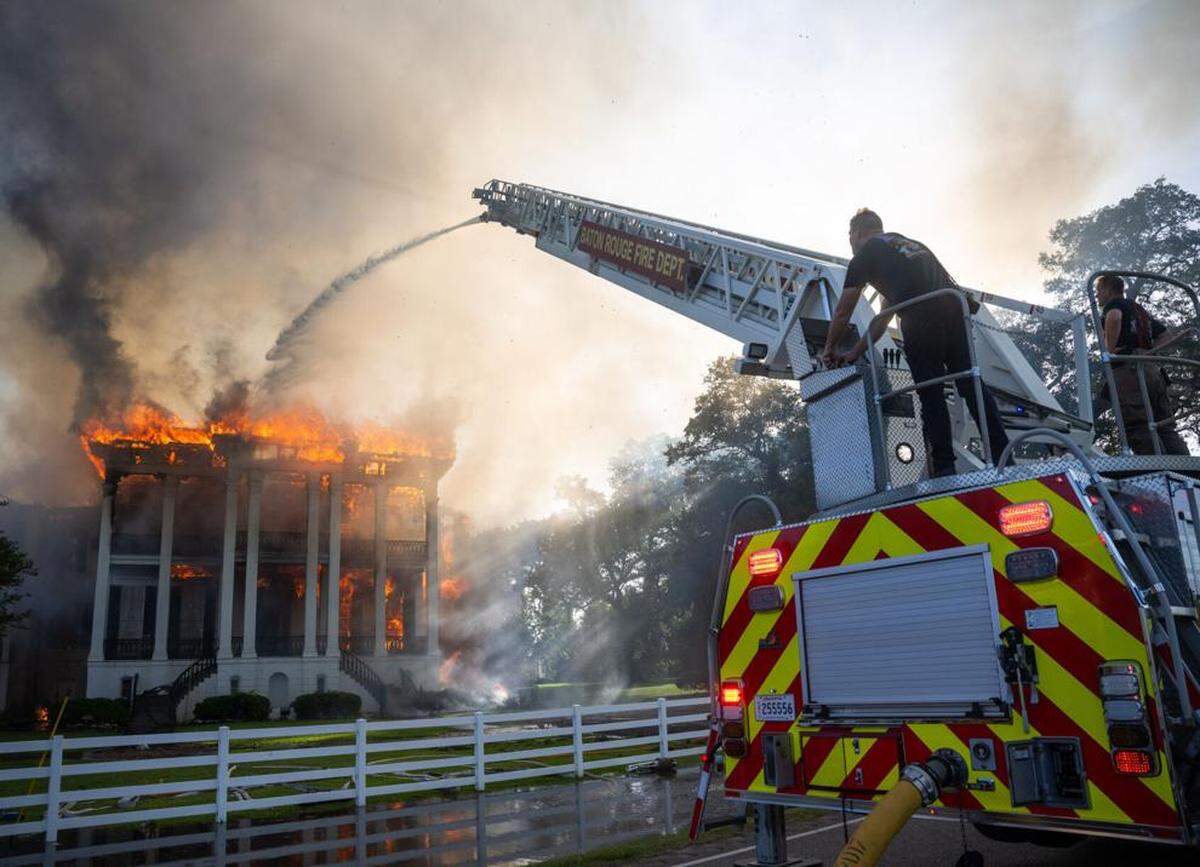 Firefighters from Baton Rouge operate Aerial 3 as flames engulf the Nottoway Plantation on Thursday, May 15, 2025, in White Castle, Louisiana.