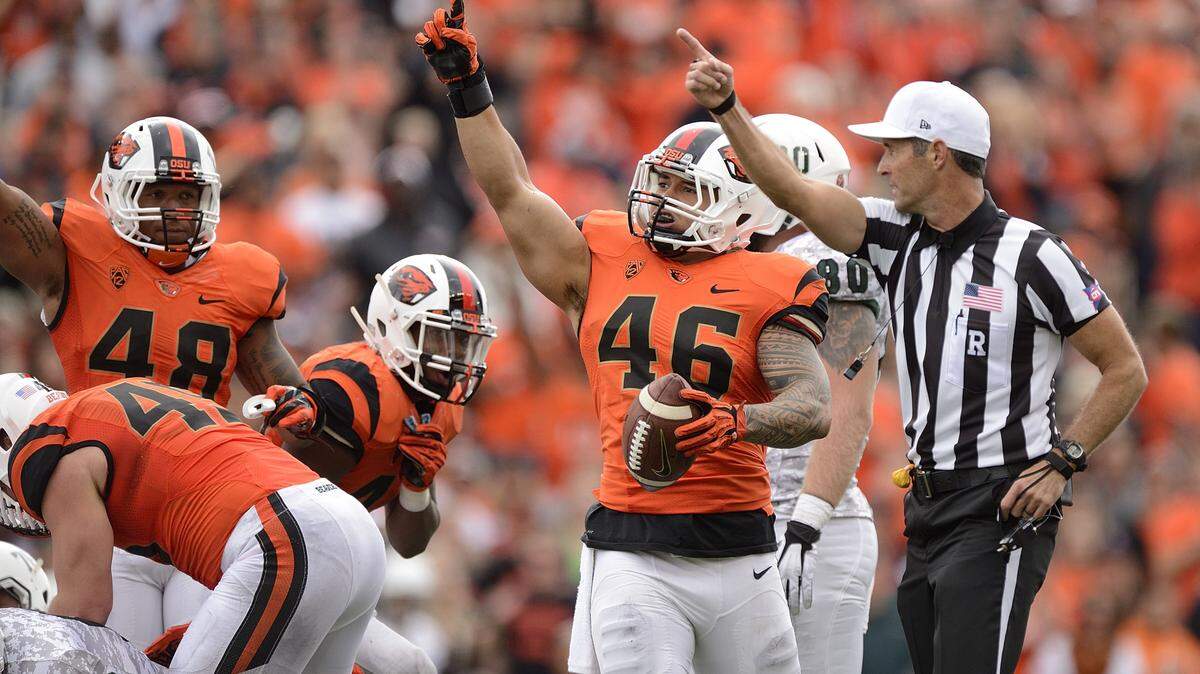 Oregon State linebacker Rommel Mageo (46) points downfield after his team recovered a fumble against Portland State during an NCAA college football game in Corvallis, Ore., Saturday, Aug. 30, 2014. (AP Photo/Troy Wayrynen)