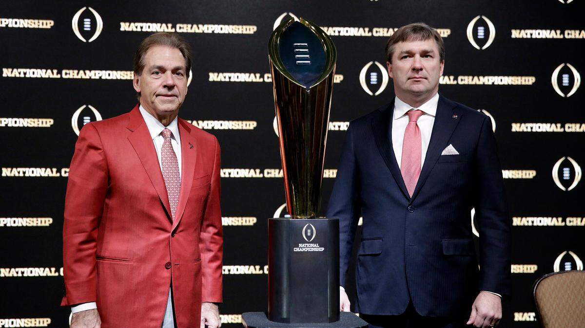 FILE - In this Jan. 7, 2018, file photo, Alabama head coach Nick Saban, left, and Georgia head coach Kirby Smart pose with the NCAA college football championship trophy at a press conference in Atlanta. Neither No. 1 Alabama nor No. 4 Georgia is anxiously awaiting their playoff fates this season, but whoever wins the SEC championship game showdown is definitely in the playoffs. The Crimson Tide could even get in with a close loss. (AP Photo/David Goldman, File)