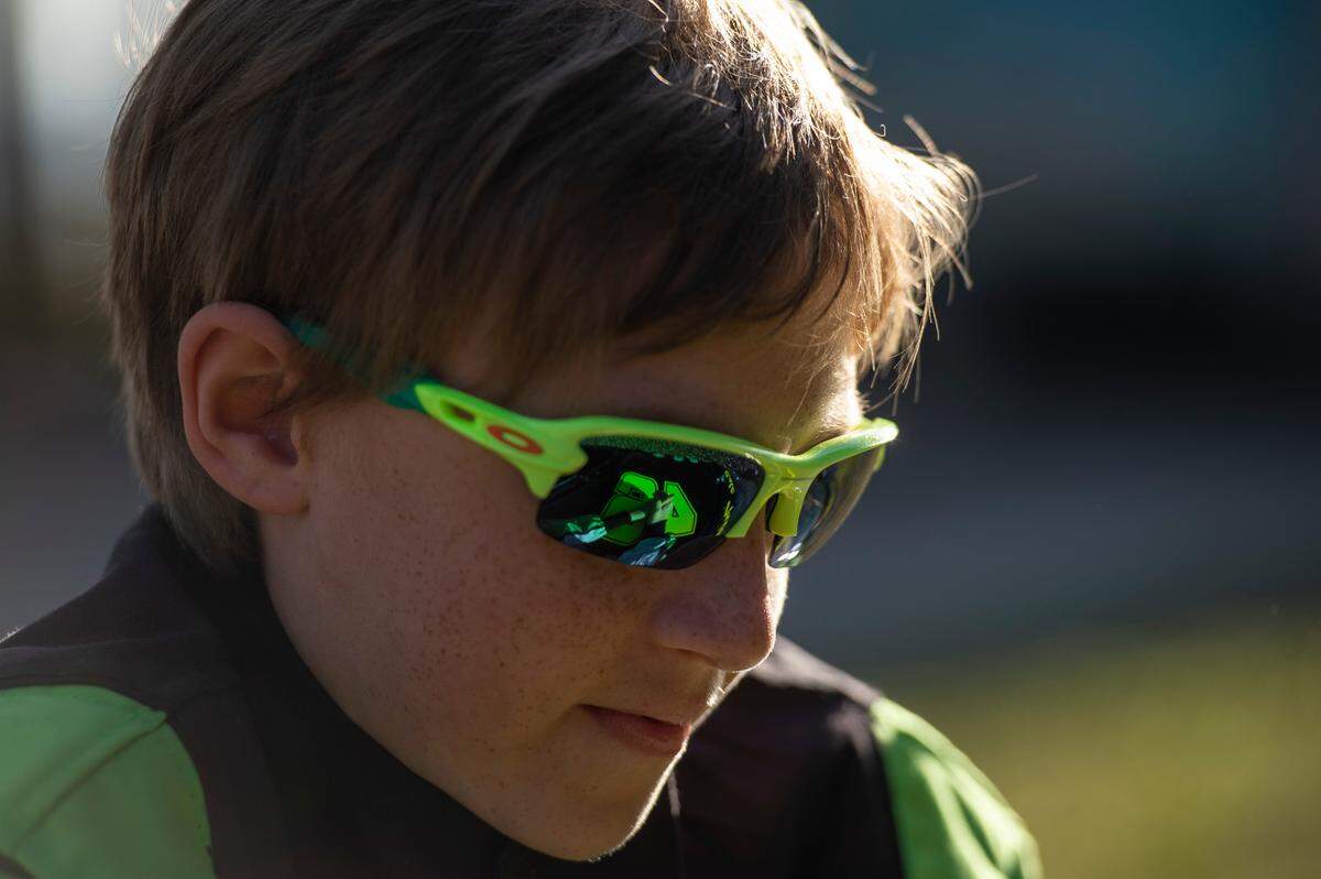 Nicolas “Cole” Denton, 11, also known as “Cole Trickle”, looks down at his Bandolero racecar at Pascagoula Beach Park in Pascagoula on Thursday, March 10, 2022.