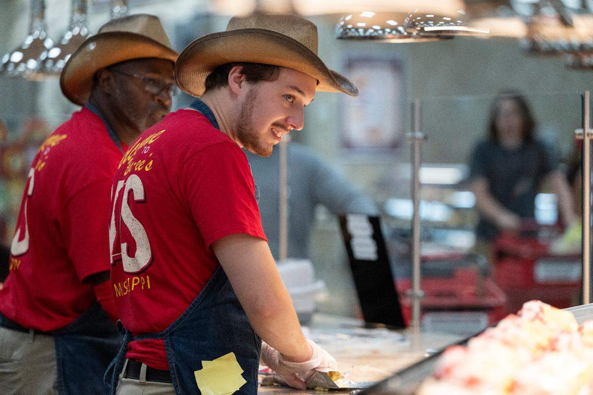 Workers prepare hot food during opening day of Buc-ee’s first Mississippi location in Harrison County on Monday, June 9, 2025.