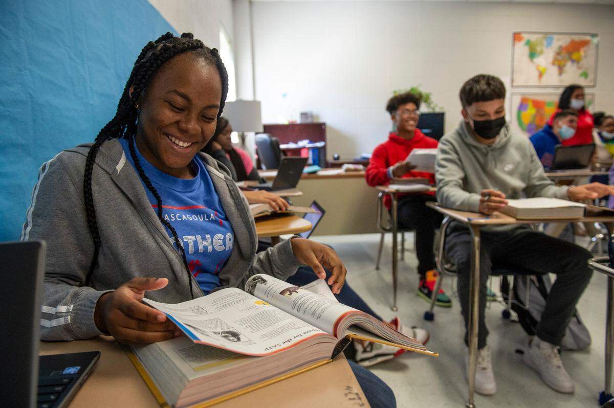 Camelee Smith, left, looks at her textbook during class at Pascagoula High School in Pascagoula on Monday, Oct. 25, 2021.