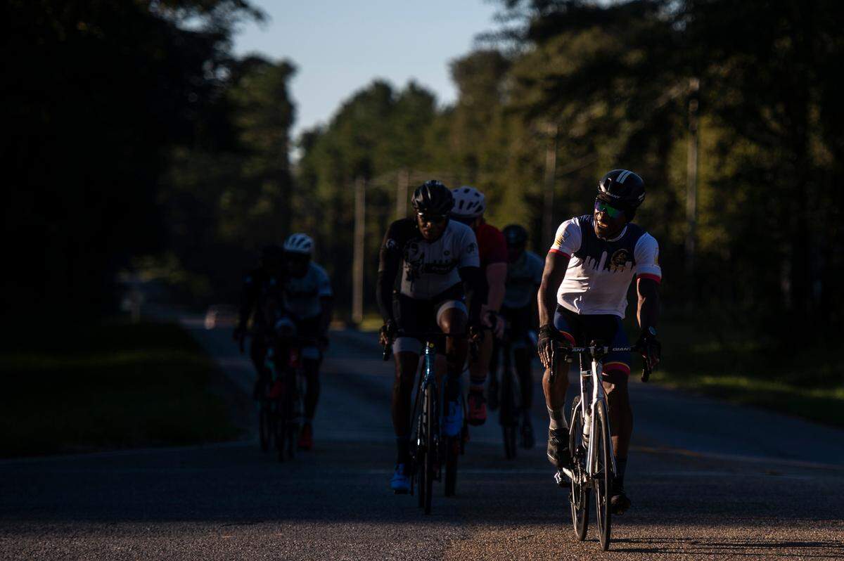 Members of Soul City Cycling, Bay Rollers, and the Major Taylor Cycling Club of Louisiana, bike through an intersection in Woolmarket on Saturday, Sept. 25, 2021.