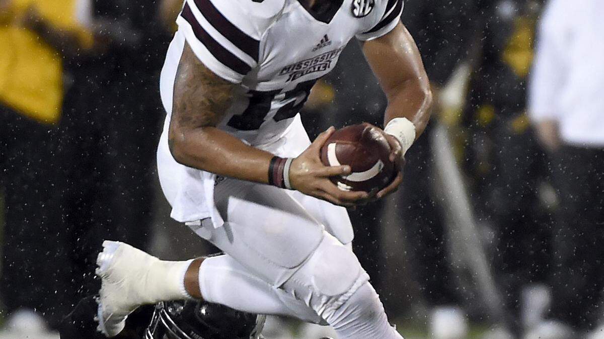 L.G. PATTERSON/ASSOCIATED PRESS 
 Mississippi State quarterback Dak Prescott (15) runs with the ball past Missouri linebacker Kentrell Brothers Thursday in Columbia, Mo.