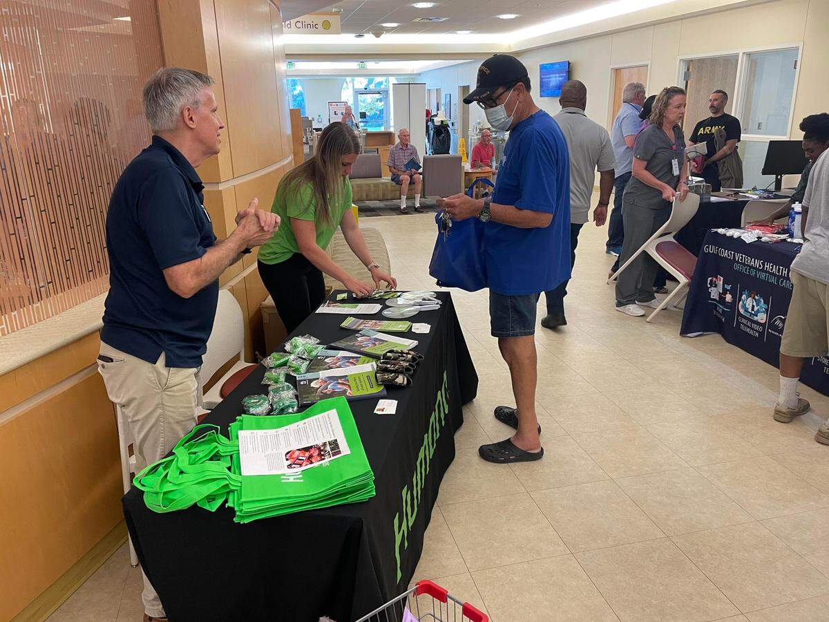 A veteran receiving information from one of the booths at the PACT Act event on July 19, 2023.