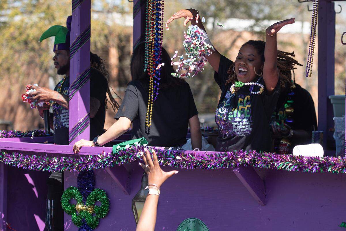 Krewes toss beads and other throws during the Jackson County Carnival Association Mardi Gras parade in Pascagoula on Saturday, March 1, 2025.
