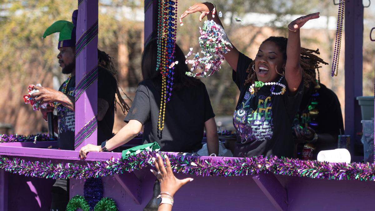 Krewes toss beads and other throws during the Jackson County Carnival Association Mardi Gras parade in Pascagoula on Saturday, March 1, 2025.