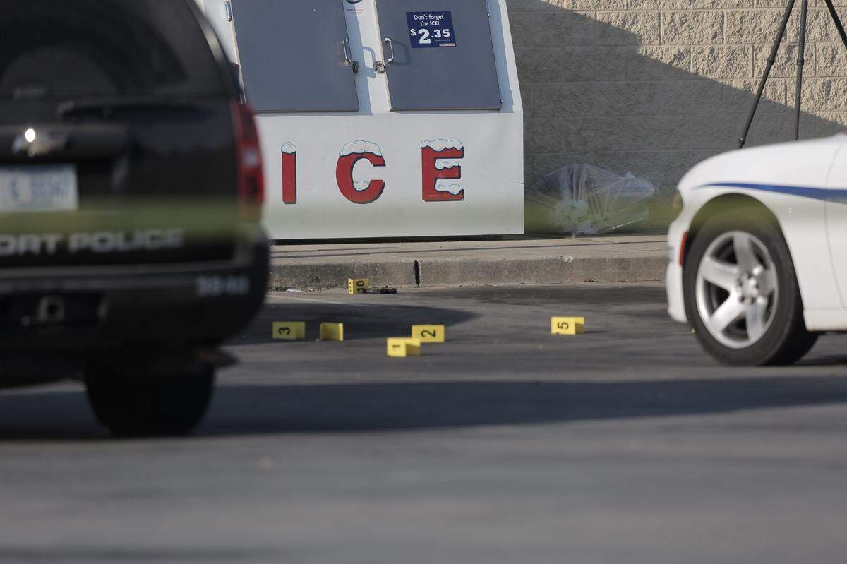 Police mark a piece of evidence in the parking lot of Family Dollar on Pass Road in Gulfport after an officer-involved shooting on October 6, 2022.