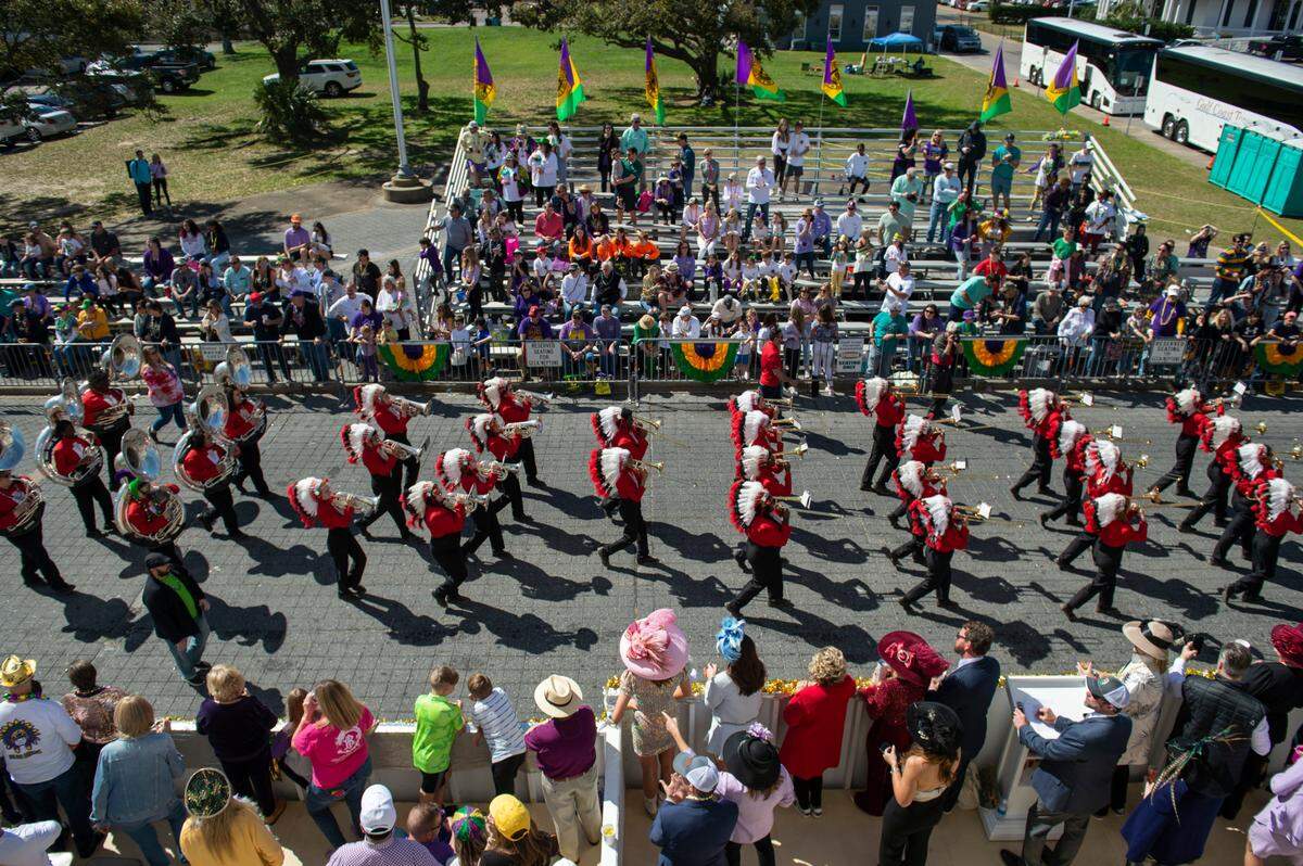 The Biloxi High School marching band parades past city hall during the Gulf Coast Carnival Association Mardi Gras Parade in Biloxi on Tuesday, March 1, 2022.