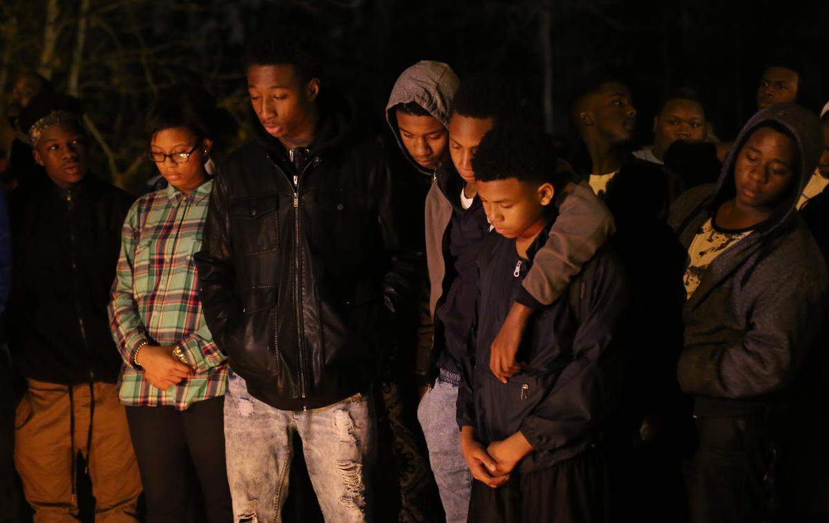 AMANDA McCOY/SUN HERALD Friends gather on Monday, January 25, 2016 for a memorial for Nigel Poole near the scene of his Jan. 25 murder in Gulfport.