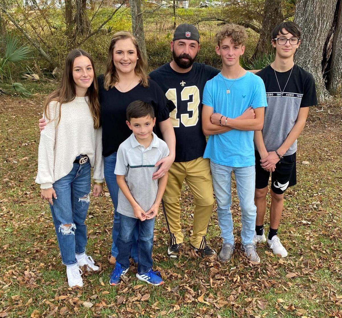 Alicia and West Dixon, back center, are pictured with their four children (left to right) Kylie, Jax, Kade and John. The Youngsville family recently sued home builder D.R. Horton, alleging construction errors and improper repairs made during warranty claims have led to toxic mold in their home.