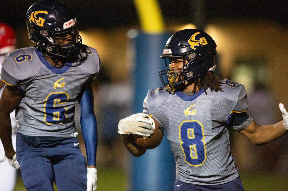 Gautier’s Kainen Rush (#8) and Cortorian Keeton (#6) celebrate after Rush scores a touchdown against Pascagoula at Gautier High School in Gautier on Friday, Sept. 2, 2022.