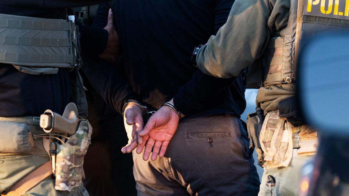 Immigration and Customs Enforcement agents apprehend an undocumented migrant in Herndon, Virginia, on Jan. 15.
