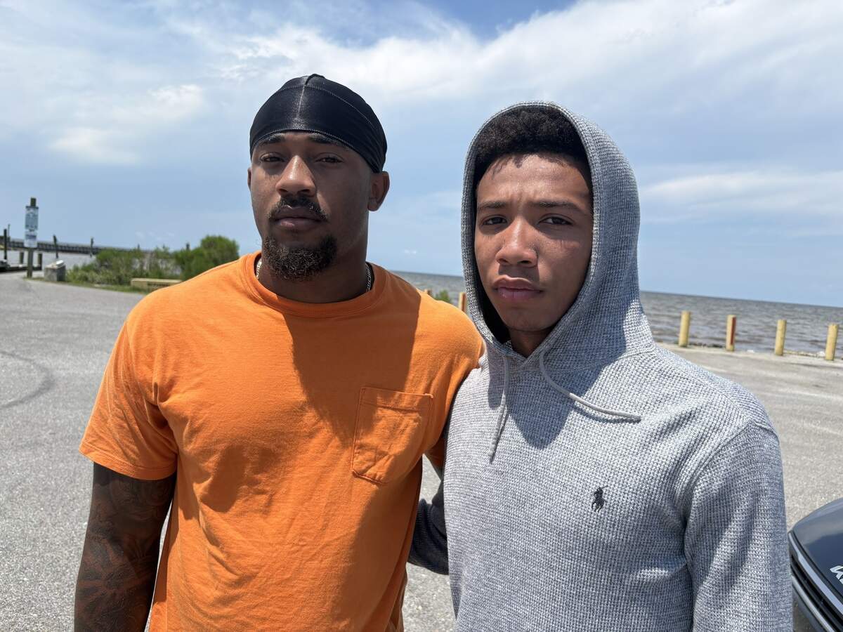 Trace Carter, left, and Jayvon Williams, right, were longtime friends of Nolan Xavier Wells, whose body searchers believe they recovered Monday morning off the western tip of Horn Island. The young men were among family and friends who comforted one another at the Lake Mars Boat Launch, where emergency responders staged search boats. Williams, who was also on Horn Island for the Fourth but on a different boat from Wells, visited with Wells shortly before he went missing.