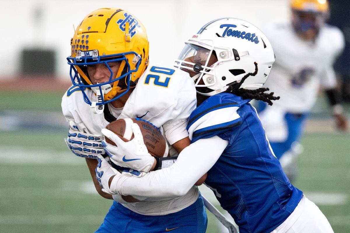 St. Martin wide receiver Dawsey Sullivan (20) is brough down by Stone defensive back Fabian Dawkins (0).