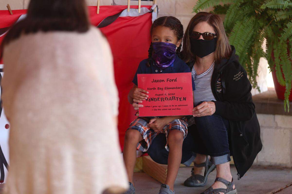 Parents take first day photos outside of North Bay Elementary on the first day of school.
