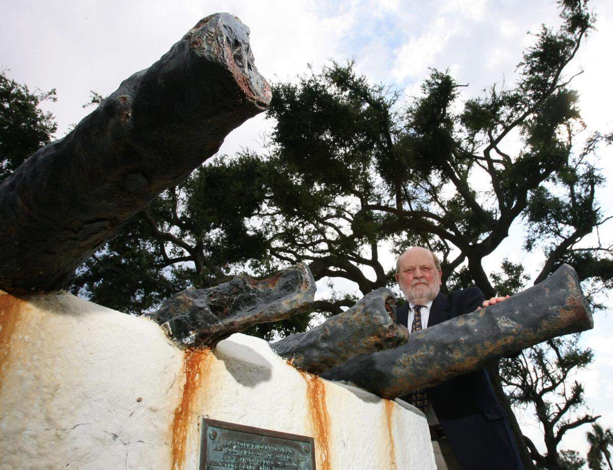 Historian Charles Sullivan poses with the cannons from a boat that sunk in Biloxi Back Bay during a hurricane in 1722. The cannons are the oldest physical evidence of hurricanes on the Mississippi Coast.